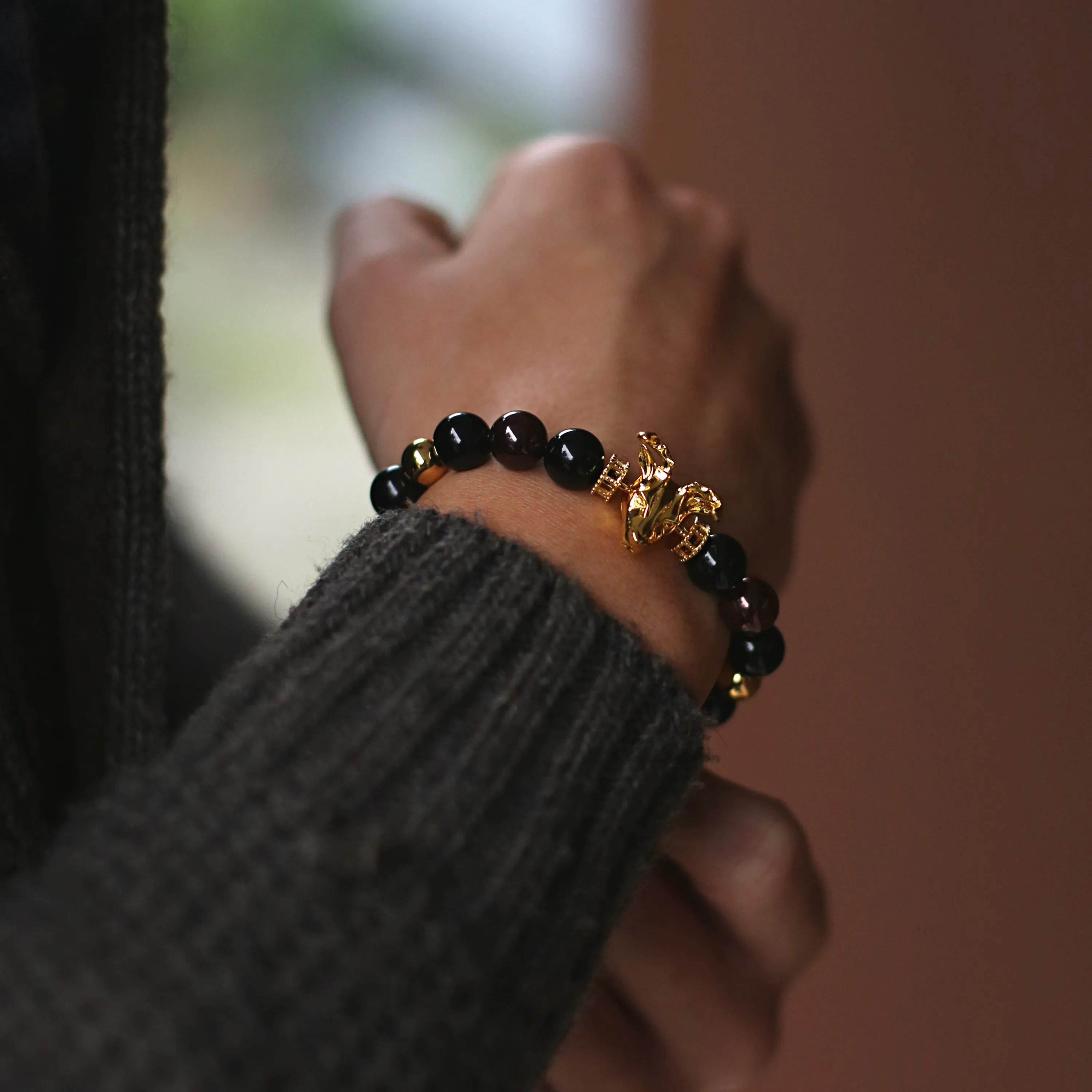 Gold Deer, obsidian, garnet bracelet with gold connector